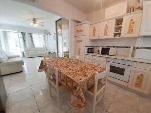 a kitchen with a table with a table cloth on it at Palais des Iles in Cannes