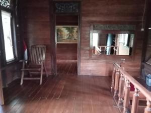 a room with a staircase and a chair in a house at Villa Ainun in Pasirmuncang 1