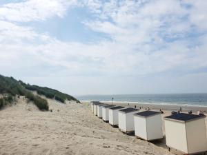 a row of beach huts on a sandy beach at Beachhouse Renesse 2645 in Renesse