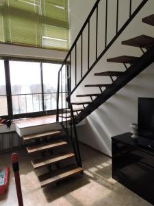 a spiral staircase in a room with a window at LightHouse in Albissola Marina
