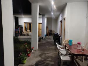 a room with a table and chairs and a dining room at Buddha guest House nubra in Deskit