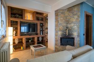 ein Wohnzimmer mit einem Sofa und einem Steinkamin in der Unterkunft Ferienhaus Sicilysun Holidays Emilia in Letojanni