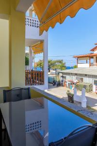 a villa with a pool and a view of the ocean at Agapitos Apartments in Nikiti