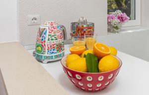 a bowl of oranges on a counter with glasses of orange juice at Luxury New !!! Apartment One and Only with terrace & free bikes in Poreč