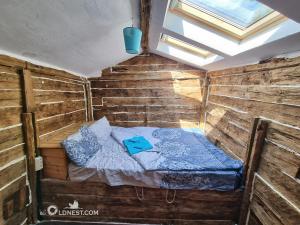 a room with a bed in a wooden cabin at The Old Nest in Madzharovo