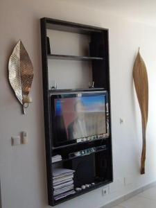a television in a black frame on a wall at Casablanca in Nerja