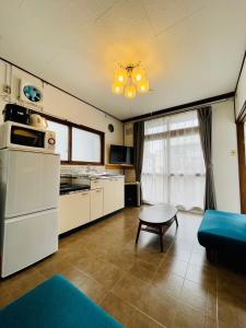 a kitchen with a couch and a table in a room at サービスアパ―トメントSAPPORO札幌さくら2-3 in Sapporo