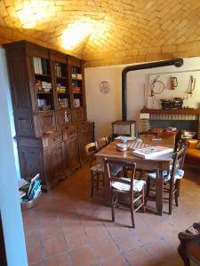 a dining room with a wooden table and chairs at Torre Colombaia in Salsomaggiore Terme +51 photos
