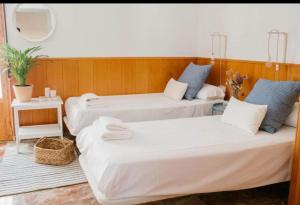 two beds sitting in a room with at SunShine Mezquita in Córdoba