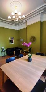 a table with a vase of flowers on top of it at Histoire de Loire La Gabare in Saumur