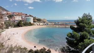 a view of a beach with people in the water at belvedere acqua dolce 1 in Cala Gonone