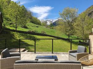 a patio with couches and a view of a mountain at Maison authentique in Gavarnie