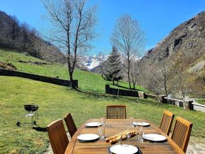 a wooden table with chairs around it with a view at Maison authentique in Gavarnie