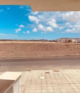 an empty road in the middle of the desert at Cozy apartments and deluxe lofts in Fuerteventura in Cotillo