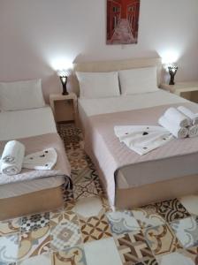 a bedroom with two beds with towels on them at amorgaia3 in Katapola