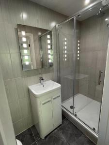 a bathroom with a sink and a shower and a toilet at George Canning Denmark Hill, London in London