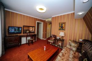 a living room filled with furniture and a tv at Sharden Villa Boutique Hotel in Tbilisi City