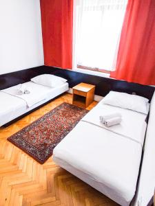 a room with two beds and a window at Apartmani Ankica in Crikvenica