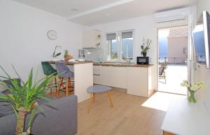 a kitchen and living room with a view of the ocean at Studio Apartman Karlita in Slano