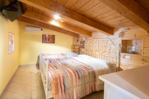 a bedroom with a bed in a room with wooden ceilings at Trabocco del Borgo in Treglio