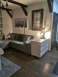 a living room with a couch and a table at Apartament Woda Morska in Ustka