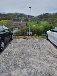 two cars parked in a gravel parking lot at Ferienwohnung Elvira in Dätzingen
