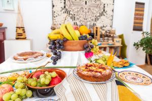 a table topped with plates of food and fruit at Hotel Ristorante S'Ortale in Orosei