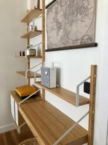 a room with wooden shelves and a desk at Dé Studio, oase van rust en romantiek in de stad. in Antwerp