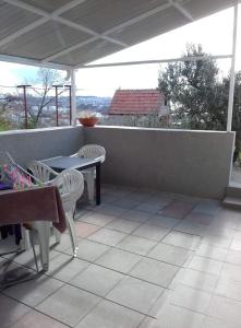 a patio with two chairs and a table and a table at Stone Guest House in Split