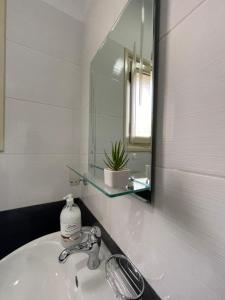 a bathroom with a sink and a mirror at Rent rooms Loren in Vlorë