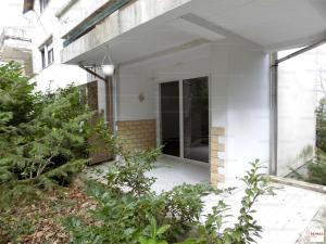 a house with a glass door in a garden at Romantic two bedroom apartment in the hills of Budapest with private parking in Budapest