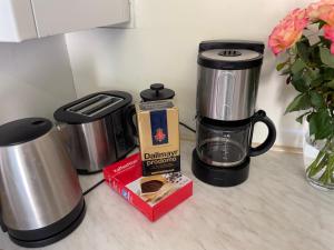 a coffee maker and a box on a kitchen counter at Wehr Orchidee Apartment in Wehr