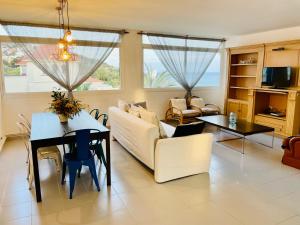 a living room with a couch and a table at La Marina SeaView Penthouse in Sitges