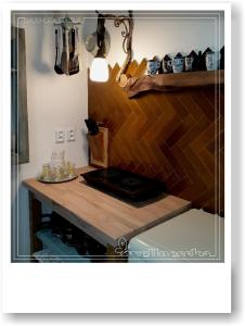 a counter in a kitchen with a wooden table at Wellnesska Vyhne in Vyhne