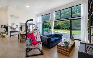 a living room with a blue couch and a swing at Naturaleza y tranquilidad in Salta