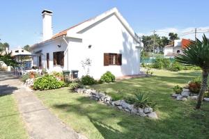 ein kleines weißes Haus mit einem Rasenhof in der Unterkunft Casa;campo-praia-Lisboa (4 quartos) in Corroios