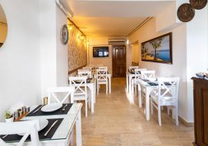 a restaurant with white tables and white chairs at Cheers Vera Edition Hotel in Istanbul