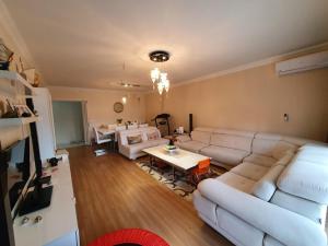 a living room with a white couch and a table at Large Aparment NilResidance in Bursa