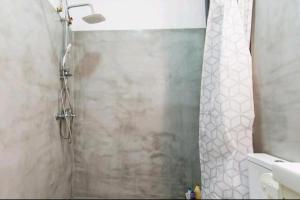 a shower in a bathroom with a shower curtain at Explore a New Arts District from a Hip Studio Flat in Athens +13 photos
