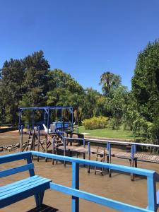 a group of blue benches in a park at Itaca delta cabañas in Tigre