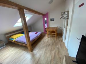 a bedroom with a bed and a desk in a room at Old Town Apartments S12 in Olomouc