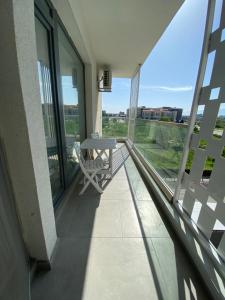 a balcony with a table and chairs on it at Apartament Park View Campus in Constanţa