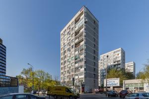 a tall building on a city street with cars at SuperApart Polna 30 in Warsaw