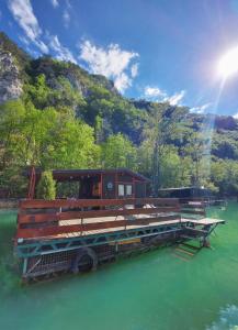 a boat sitting on the water in a river at Raft Perućac in Rastište