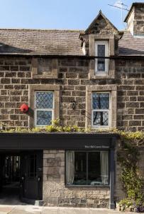a brick building with a black door and windows at Luxe Design - Chic Cottage - Heart of Rothbury in Rothbury