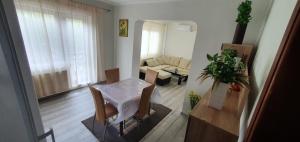a living room with a table and a couch at Casa Alex si Daiana in Orşova +14 photos