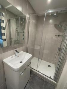 a bathroom with a shower and a sink and a toilet at George Canning Denmark Hill, London in London