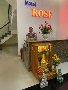 a man standing behind a podium in a store at Rose in Hue