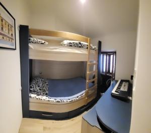 a room with two bunk beds and a desk at Skipper in Piran