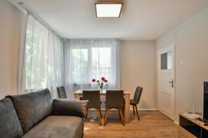 a living room with a couch and a table with chairs at House Stavrevi in Varna City